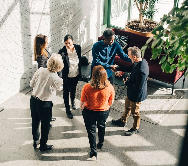 Gruppo di persone in ufficio che parlano tra di loro