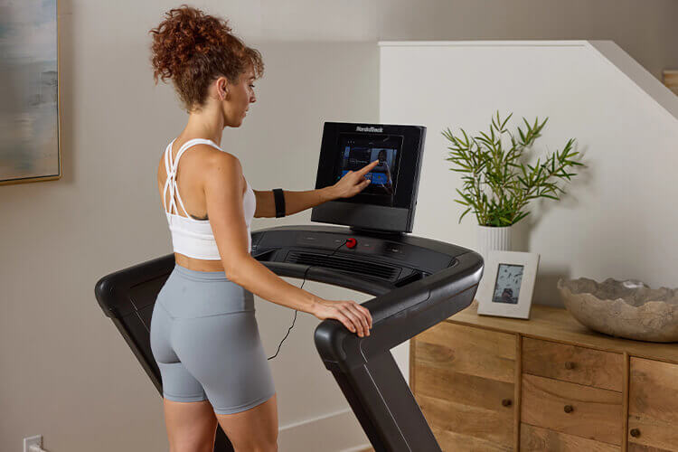 Ragazza che si allena con tapis roulant Nordictrack Commercial 1250