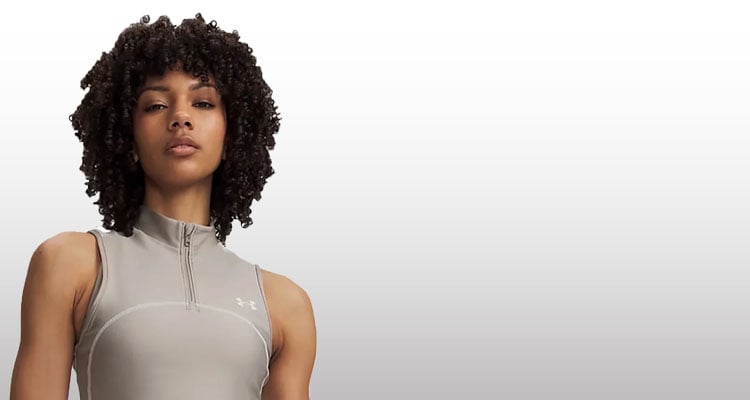 Ragazza che indossa top fitness Under Armour 